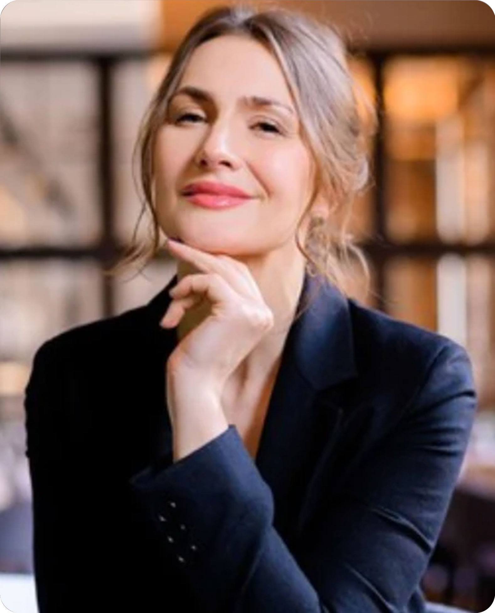 Man with short hair wearing a dark jacket against a neutral background.